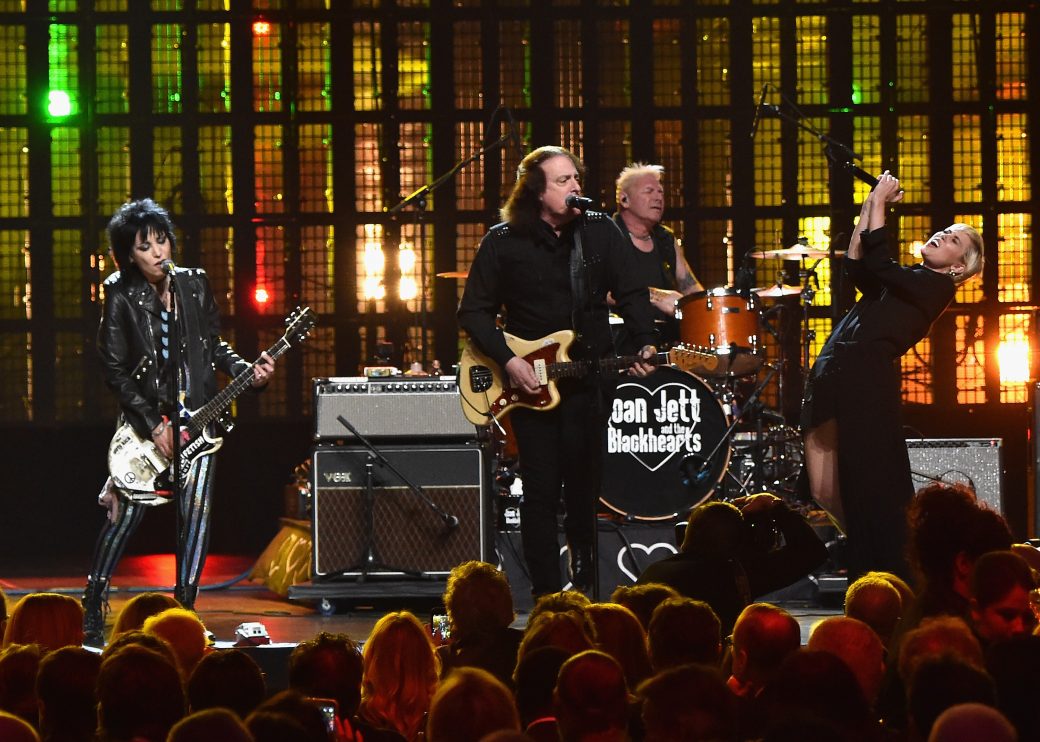 Joan Jett, Tommy James, and Miley Cyrus perform on stage